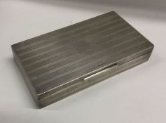 An engine turned silver cigarette case with hinged