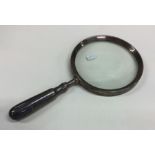 An unusual silver mounted magnifying glass with ta