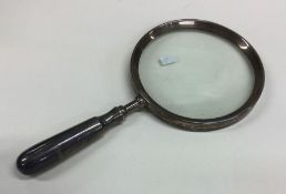 An unusual silver mounted magnifying glass with ta