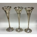 A good set of three tapering silver spill vases. S