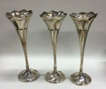 A good set of three tapering silver spill vases. S