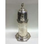 A tall silver lighthouse shaped caster decorated w