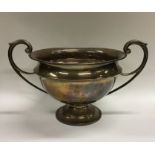 A heavy Edwardian silver two handled cup on spread