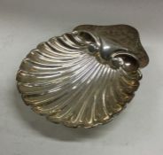 A heavy Edwardian silver butter shell on ball feet