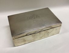 A rectangular hinged top silver cigarette box. Lon