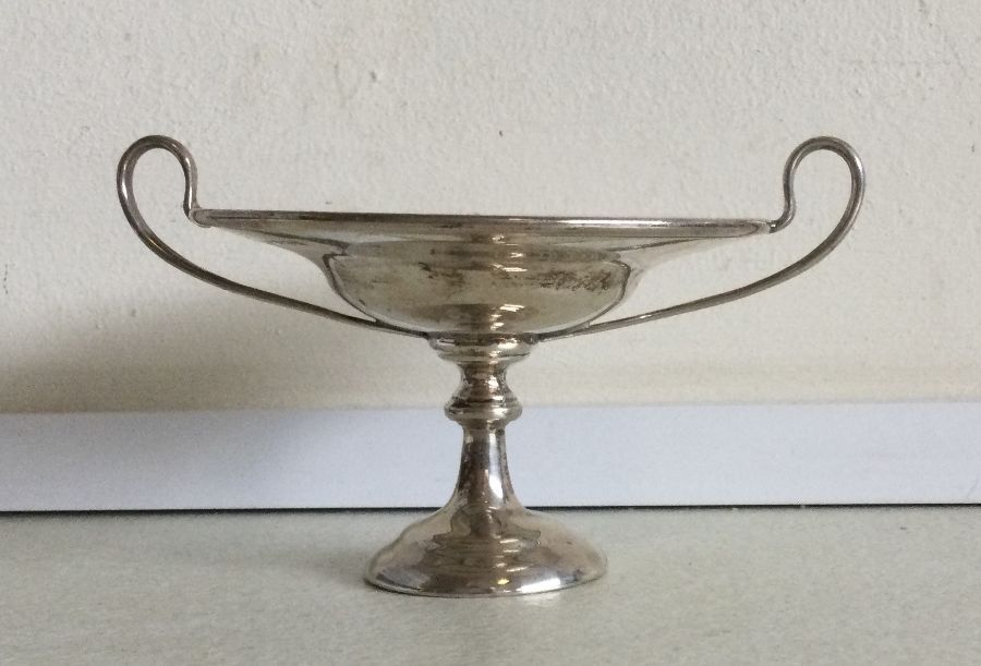 A small silver two handled sweet dish on pedestal