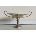 A small silver two handled sweet dish on pedestal