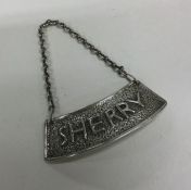 A heavy textured silver wine label for 'Sherry' on