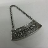 A heavy textured silver wine label for 'Sherry' on