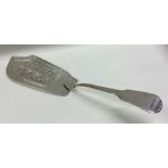 A pierced fiddle pattern silver fish slice. London