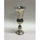 A large tapering silver Kiddush cup with engraved