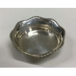 A small silver bottle stand with shaped decoration