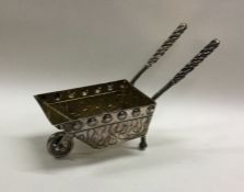 An unusual silver model of a wheelbarrow with twis