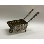 An unusual silver model of a wheelbarrow with twis