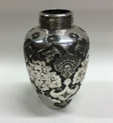 A Persian silver chased vase decorated with flower