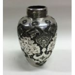 A Persian silver chased vase decorated with flower