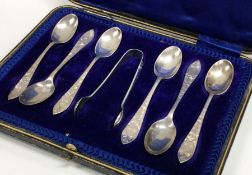 A boxed set of six silver bright cut teaspoons. Sh