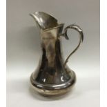 A heavy Edwardian silver Arts and Crafts cream jug