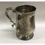 A Georgian baluster shaped silver mug on spreading