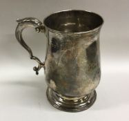 A Georgian baluster shaped silver mug on spreading