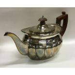 A Victorian silver teapot of half fluted design. L