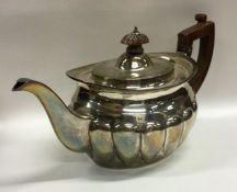 A Victorian silver teapot of half fluted design. L