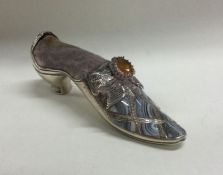 A novelty silver pincushion in the form of a shoe