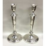 A heavy pair of tall Georgian silver tapering cand