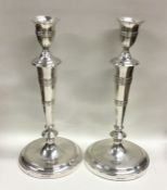A heavy pair of tall Georgian silver tapering cand