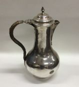 A heavy Georgian silver baluster shaped ewer with