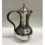 A heavy Georgian silver baluster shaped ewer with