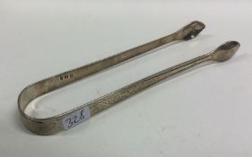 A good pair of Georgian bright cut silver sugar to