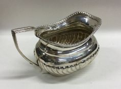 An Edwardian silver half fluted cream jug with gad