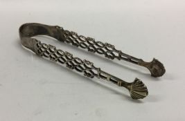 A pair of heavy Georgian silver pierced sugar tong