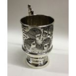 An attractive silver christening mug decorated wit