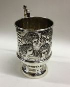 An attractive silver christening mug decorated wit