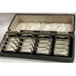 A cased set of four silver five bar toast racks. B