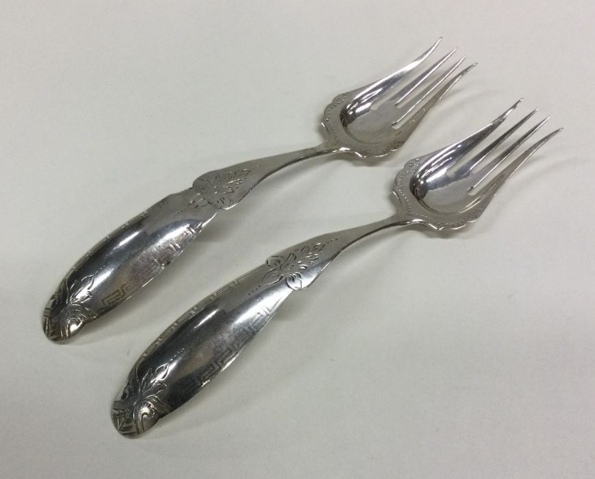 A large pair of Dutch silver engraved forks with p