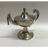 A silver oil burner in the form of an Aladdin's la