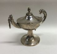 A silver oil burner in the form of an Aladdin's la