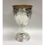 A good chased Georgian silver goblet decorated wit