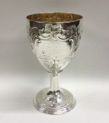 A good chased Georgian silver goblet decorated wit