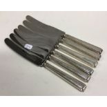 A set of six heavy silver handled table knives. Sh