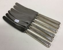 A set of six heavy silver handled table knives. Sh