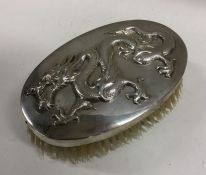 An unusual Chinese silver hairbrush decorated with