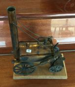 A model of Stephenson's Rocket on wooden base. Est. £10 - £15.