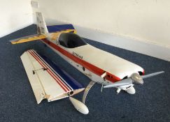 A large scratch built model Extra 300 aircraft wit