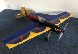 A scratch built model Extra 200 aircraft with blue