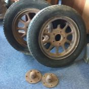 A pair of spoked wheels and caps to suit a Morris Commercial. Est. £10 - £20.