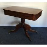 A mahogany single drawer occasional table on four
